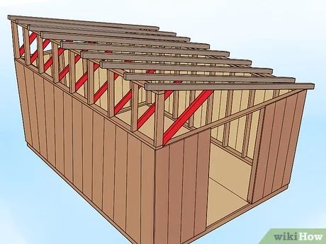 a wooden shed with red tape on the roof and sidewalls attached to it