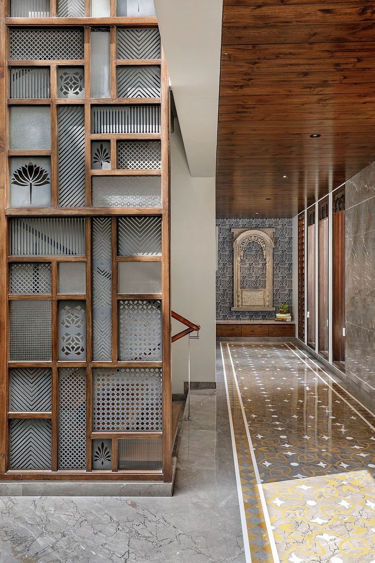 a large wooden book case sitting in the middle of a room next to a tiled floor