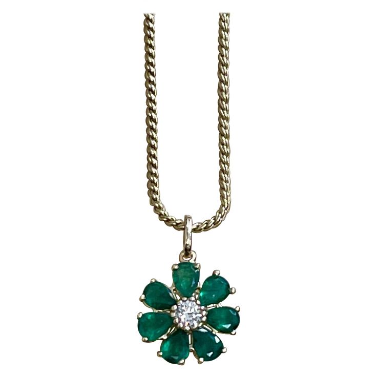 Emerald and Solitaire Diamonds Flower Pendant Necklace 14 Karat Yellow Gold Chain App0roximately 5 Carat Round Cut Emerald and 0.40 ct solitaire diamond flower pendant This exquisite Pendant is beautifully crafted with 14 karat Yellow gold 14 K gold with chain is 11.1 gm Length of the chain 16 inch Flower 18.5 MM round Fine 7 Pear Cut Emeralds with no color Enhancement are making a circle around a solitaire 40 pointer round brilliant diamond Unique flower shape Pendant Diamonds Total weight 0.40 Diamond Flower Pendant, Flower Pendant Necklace, Solitaire Diamond, Unique Flowers, Diamond Flower, Yellow Gold Chain, Flower Pendant, Flower Shape, Diamond Solitaire