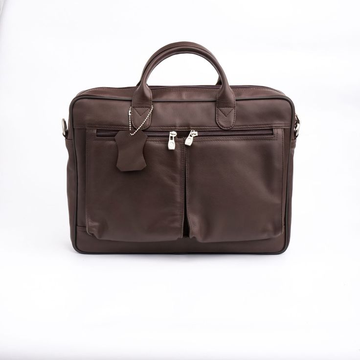 a brown leather briefcase sitting on top of a white table