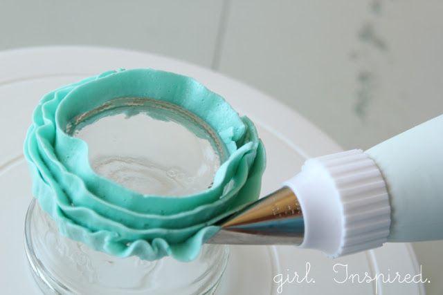 a close up of a paint brush in a jar with some frosting on it