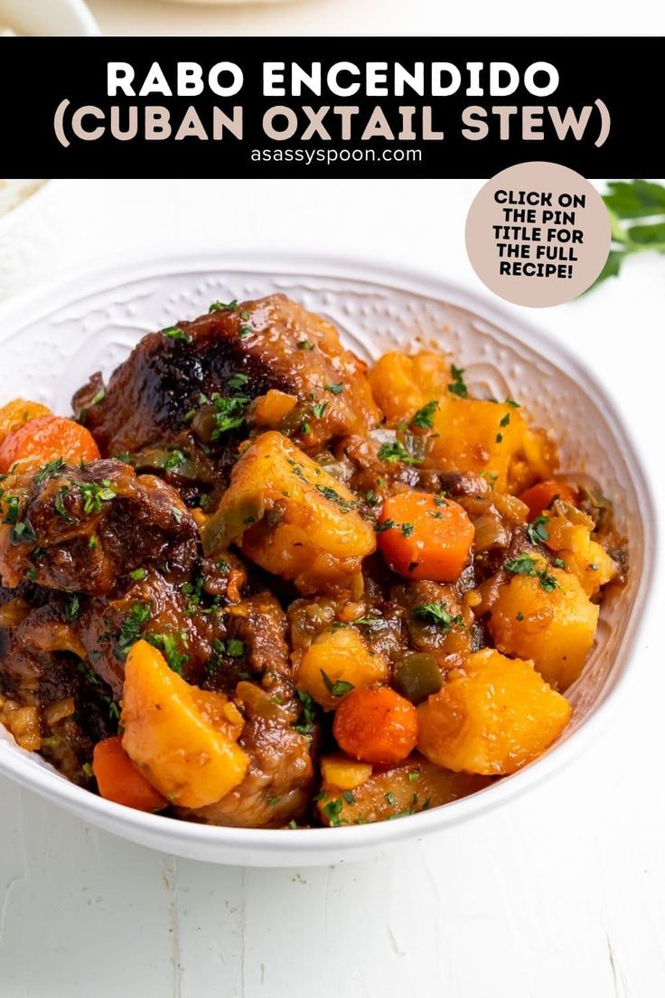 a white bowl filled with stew and vegetables