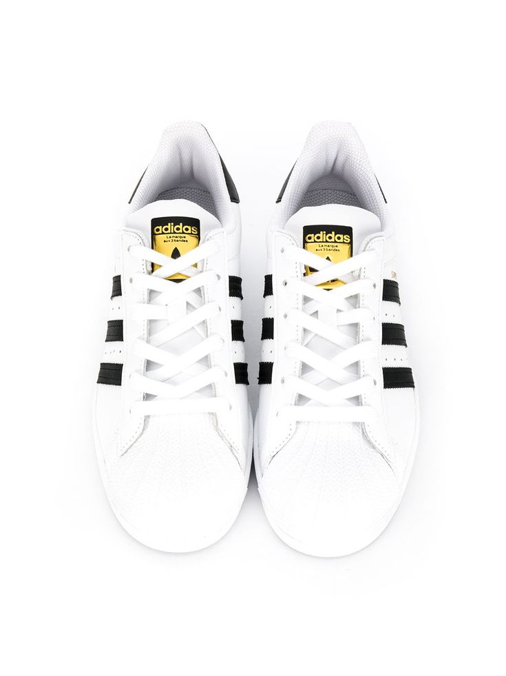 White and black leather Superstar low-top sneakers from adidas featuring a round toe, a lace-up front fastening, a logo patch at the tongue, a signature three stripe detail, a branded insole and branded heel counter. POSITIVELY CONSCIOUS: We’ve joined forces with ethical agency Good On You to give you the power to choose positively. This piece is from a brand that scores well on their key criteria. | Adidas Originals Kids Superstar low-top sneakers Adidas Logo Sporty Lace-up High-top Sneakers, Adidas Lace-up Skate Shoes With White Sole, Sporty Adidas Platform Sneakers For Streetwear, Sporty Low-top Sneakers With Elastic Laces, Low-top Platform Sneakers With Elastic Laces For Streetwear, Adidas Low-top Skate Shoes, Low-top Skate Shoes With Elastic Laces For Streetwear, Low-top Platform Sneakers With Elastic Laces, Adidas Logo Custom Low-top Sneakers For Streetwear