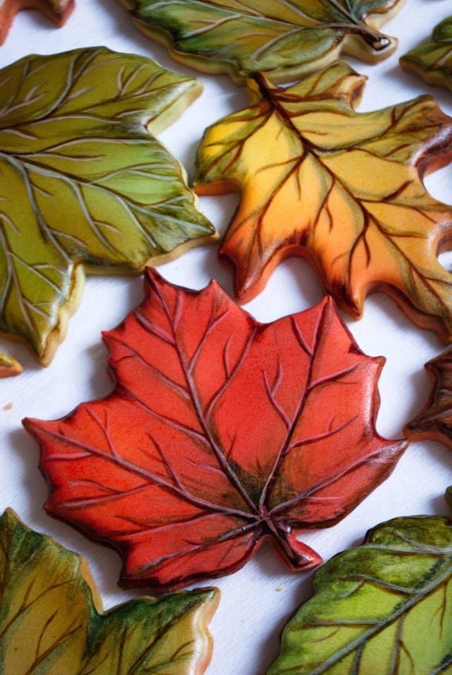 colorful leaf shaped cookies sitting on top of a table