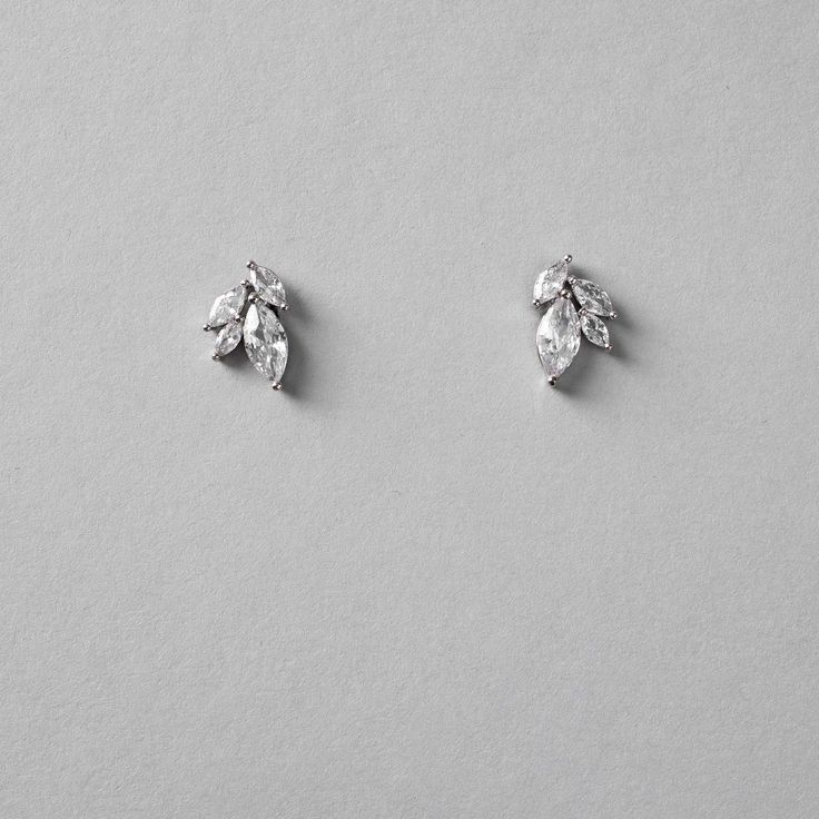 Petite leaf cluster CZ earrings for the bride or bridesmaid set in silver. They are about .5 inches long, lead, nickel, and cadmium free. Made with AAA grade cubic zirconia. Sterling Silver Cluster Earrings With Sparkling Stones For Wedding, Silver Marquise Cluster Earrings For Wedding, Wedding Cluster Earrings With Sparkling Stones In Sterling Silver, Silver Marquise Diamond Earrings For Wedding, Wedding Sterling Silver Cluster Earrings With Sparkling Stones, Silver Marquise Bridal Earrings For Wedding, Silver Marquise Crystal Earrings For Formal Occasions, Silver Leaf-shaped Earrings For Wedding, Silver Sterling Cluster Earrings For Weddings