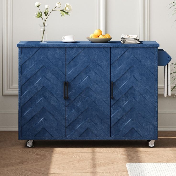 a blue cabinet with two bowls on top and some lemons in the bowl next to it