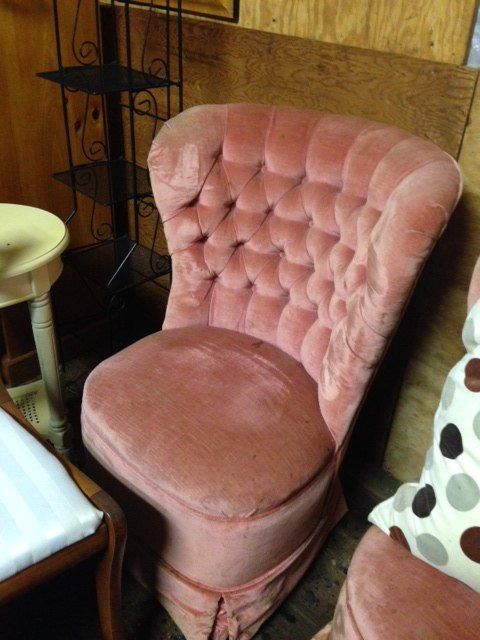 two pink chairs sitting next to each other on top of a carpeted room floor