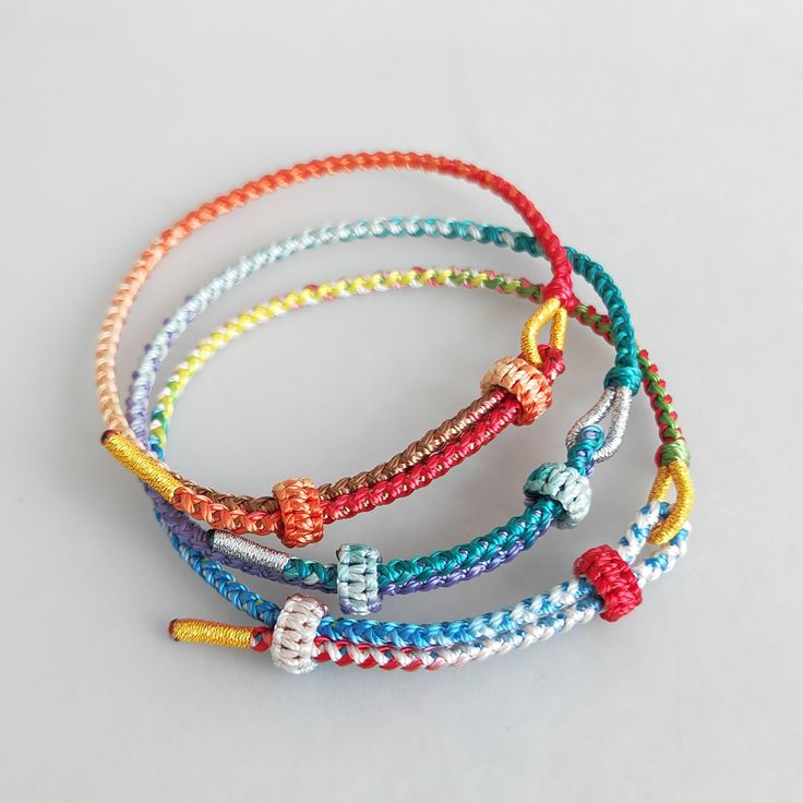 multicolored bracelets on white background with space for text