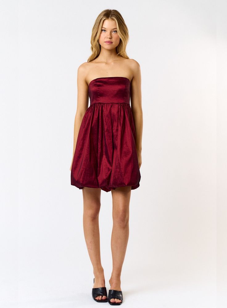 Add some fun to your holiday wardrobe with our Bubble Hem Tube Mini Dress! This dress features a playful bubble hem and a flattering tube design with a metallic red coloring. Perfect for any festive occasion, you won't want to miss out on this must-have dress. DETAILS Bubble Hem Style Mini Dress Strapless Tube Style Metallic Red Coloring Self - 50% Polyester 45% Nylon 5% Spandex Lining - 100% Polyester Care - Wash Cold - No Tumble Model: Wearing a Size Small Blue Blush is a young-contemporary wo Mini Dress Strapless, Tube Mini Dress, Mini Tube Dress, Tube Design, Bubble Hem, Bubble Dress, Denim Sweater, Holiday Wardrobe, Hem Style