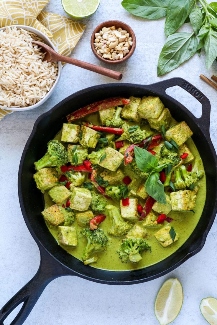 a pan filled with tofu and broccoli on top of a white counter