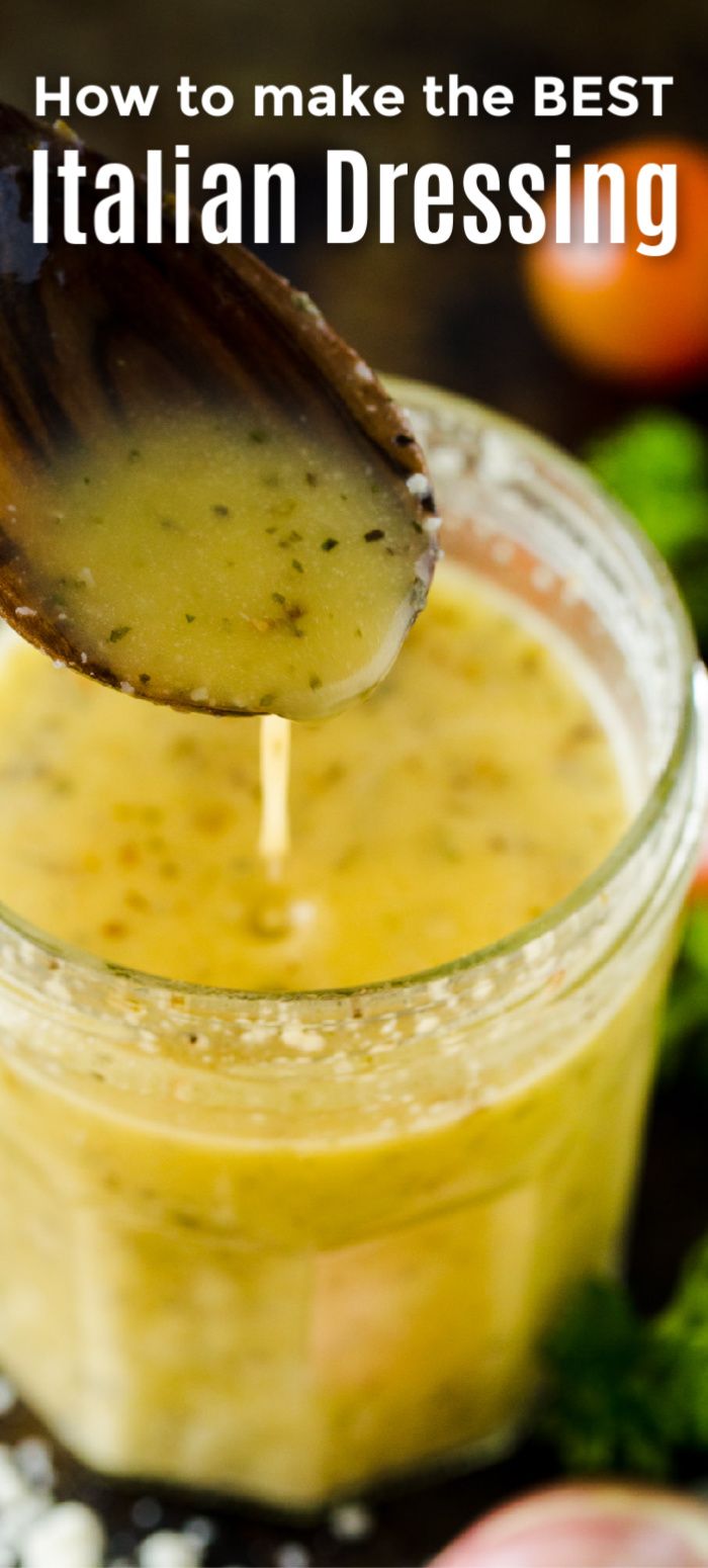 a wooden spoon is in a jar filled with yellow liquid