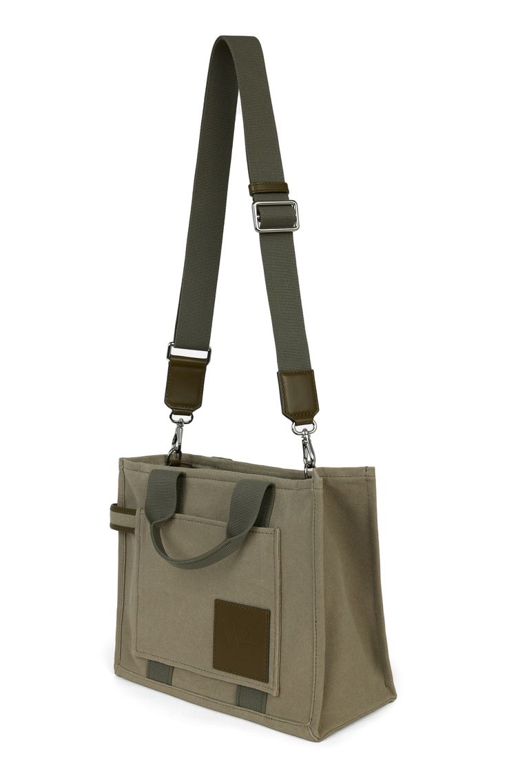 a canvas bag with two straps hanging from it's shoulder and the front pocket open