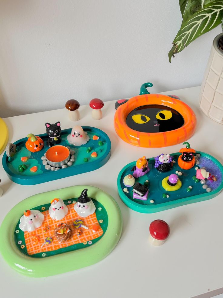 there are several plates with halloween decorations on them and one has a cat in the center