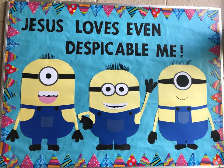 a bulletin board with three minion characters on it that says jesus loves even despicable me