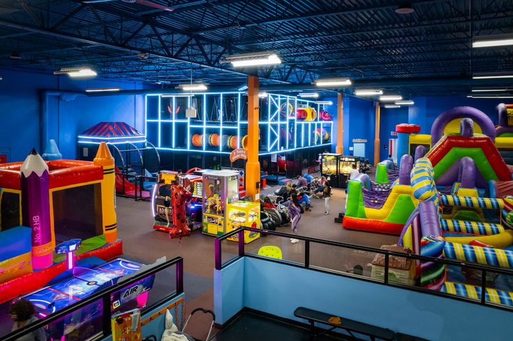 an indoor play area with slides and inflatables