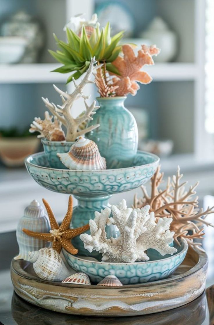 three tiered bowls with seashells and starfish in them