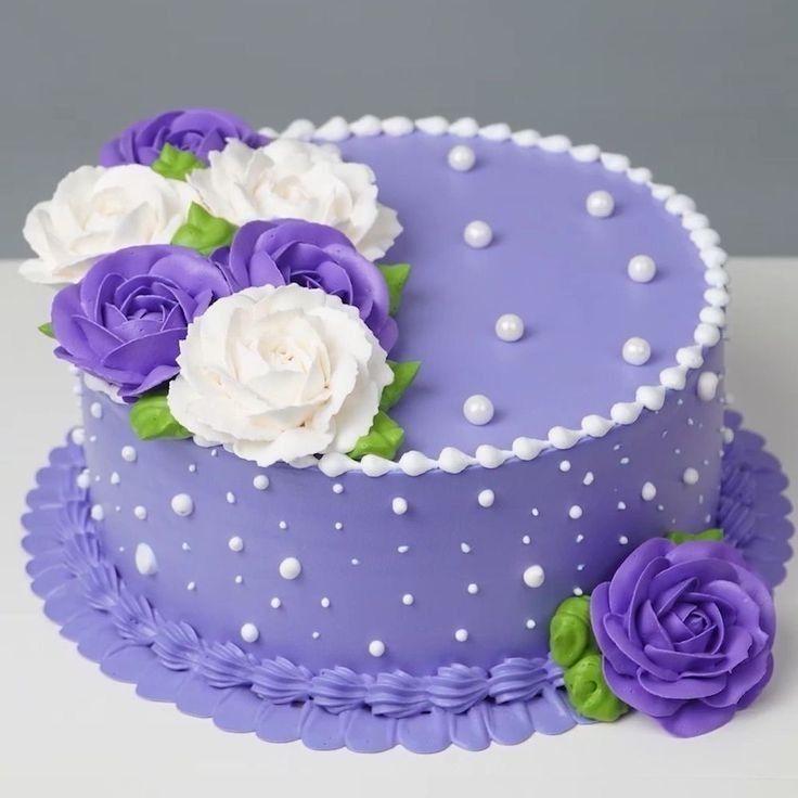 a purple cake with white and purple flowers on it