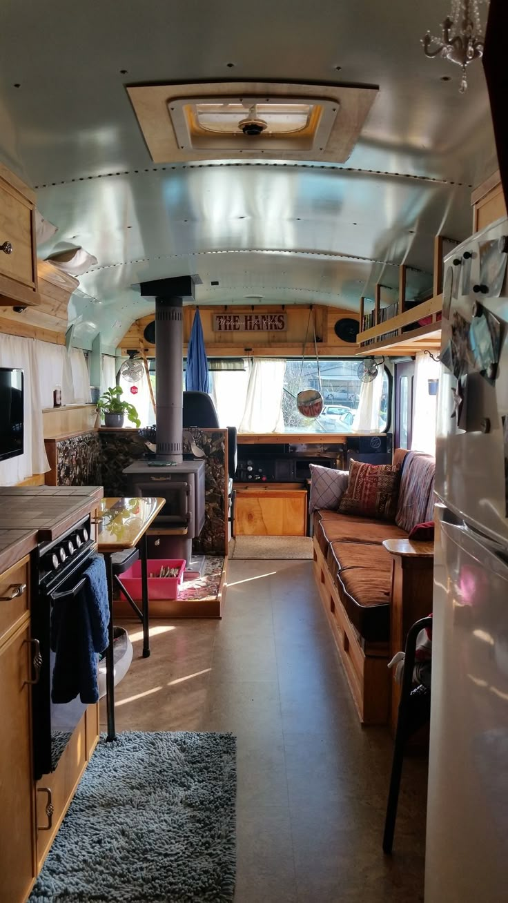 the interior of a camper with wood cabinets and an open floor plan is shown