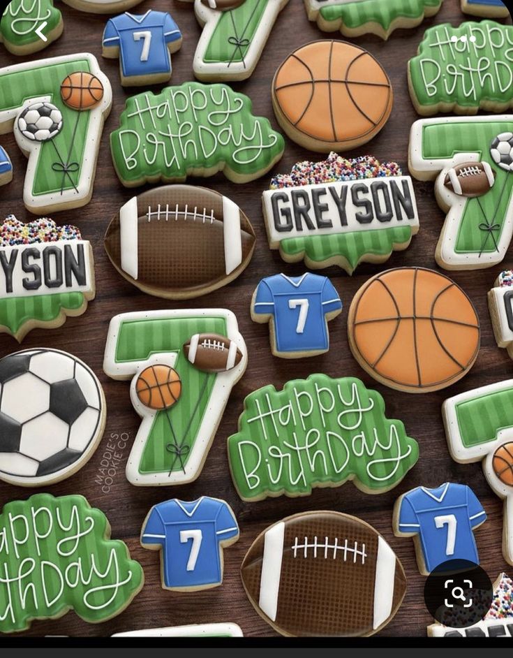 decorated cookies with sports and numbers are displayed on a wooden table for a birthday party