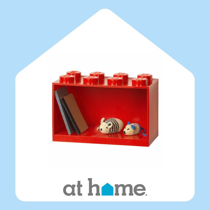 a red shelf with legos on it and the words athome above it