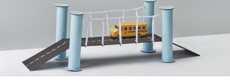 a toy train is on the track with blue poles