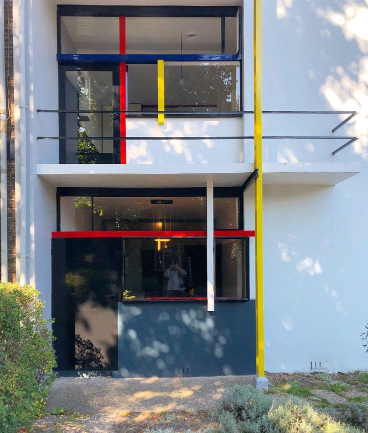 an apartment building with multicolored balconies and windows