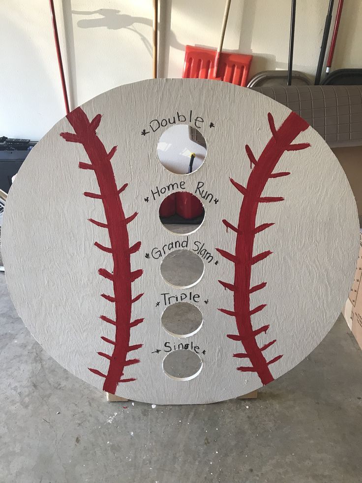 a baseball shaped plaque with the names and numbers on it