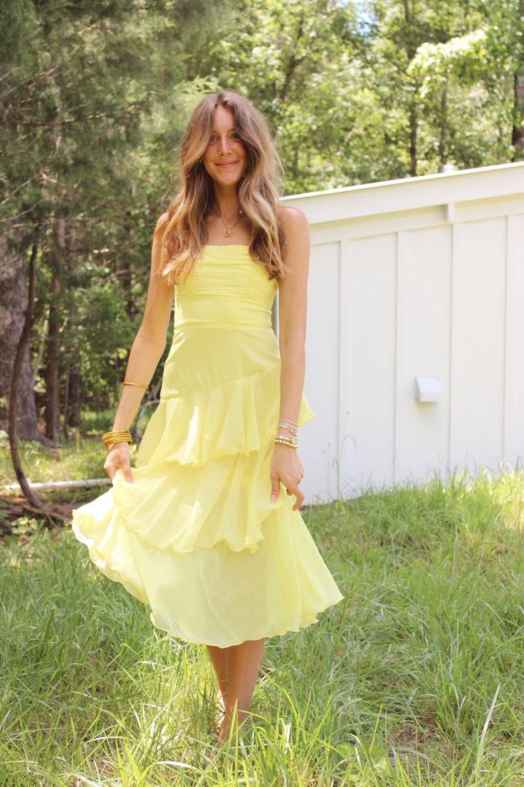 Bright yellow maxi dress with ruffle tier bottom and adjustable strap details Yellow Ruffle Dress For Spring, Spring Yellow Ruffled Dresses, Yellow Ruffled Dress For Spring, Brunch Tiered Midi Dress With Ruffled Skirt, Spaghetti Strap Midi Dress With Ruffles For Garden Party, Summer Tiered Midi Dress With Ruffled Skirt, Flowy Yellow Dress With Ruffle Hem, Summer Midi Dress With Ruffled Tiered Skirt, Spring Maxi Dress With Ruffles And Spaghetti Straps