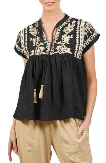 Go boho in this beautifully embroidered cotton blouse finished with front tassels, fringed short sleeves and a gathered babydoll silhouette. 27 1/2" length (size S) Split neck with ties Short sleeves 100% cotton Hand wash, dry flat Made in the USA Long Tiered Skirt, Embroidered Cotton Top, Peasant Shirt, Bohemian Style Clothing, Boho Denim, Japan Outfit, Embroidered Tunic Top, Boho Chic Outfits, Embroidery Designs Fashion