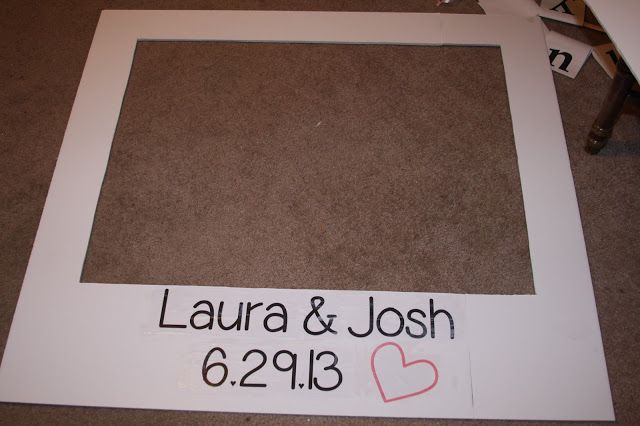 a photo frame with the name and date written on it, sitting next to a pair of scissors