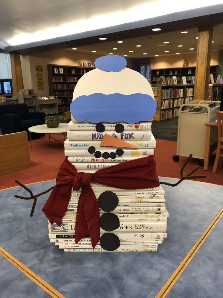 a stack of books with a snowman made out of them