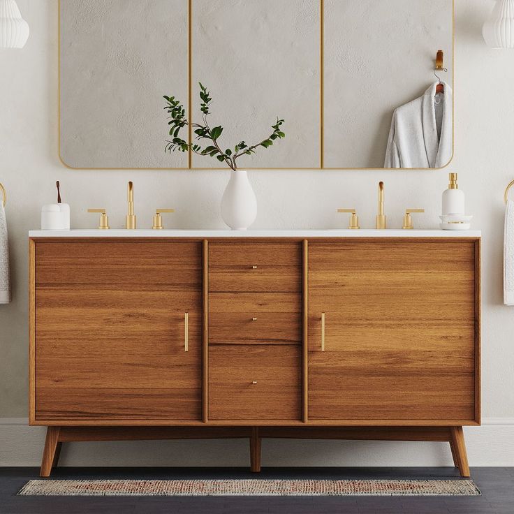 a bathroom vanity with two mirrors and vases on the top, next to it