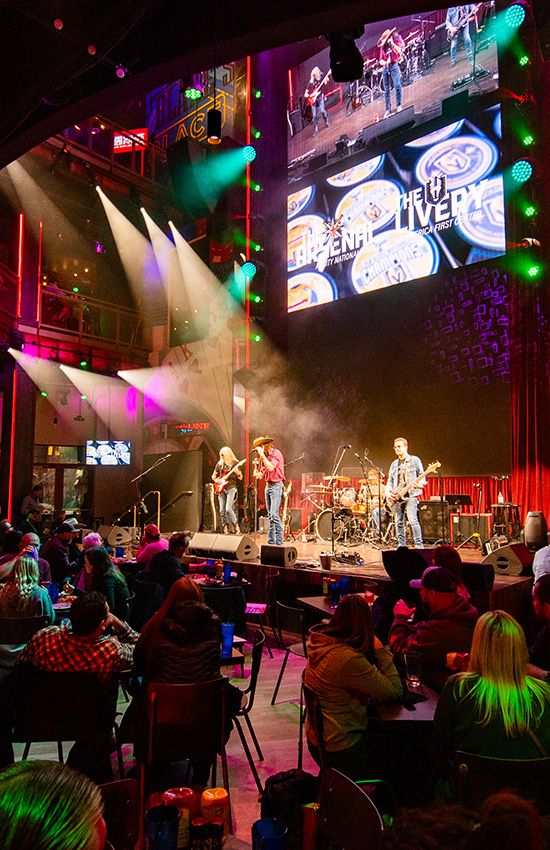 a group of people sitting in front of a stage