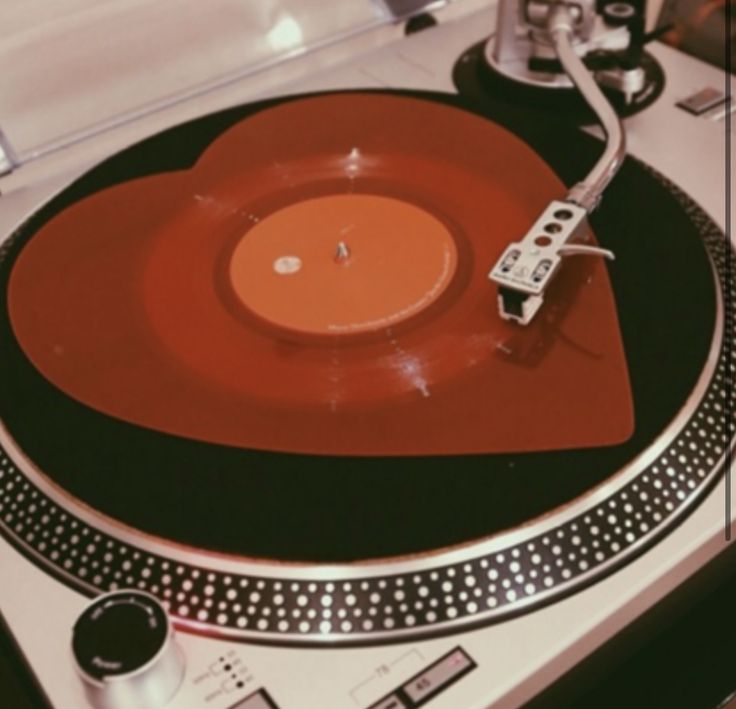 an old record player with its turntable turned upside down on a table top surface