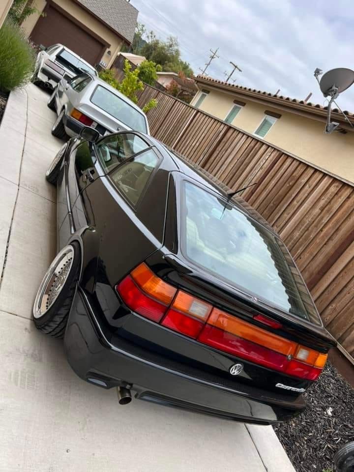 the back end of a car parked in front of a house