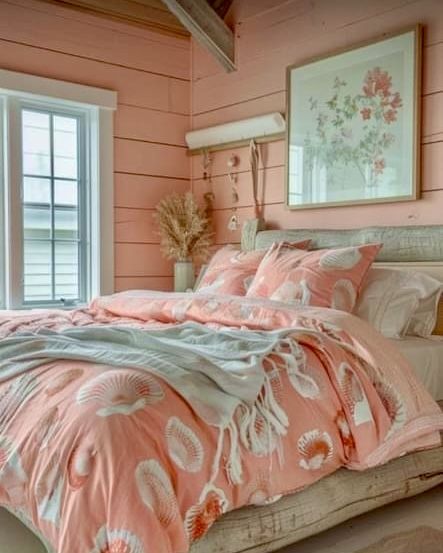 a bedroom with pink walls and bedding in the center, along with two windows