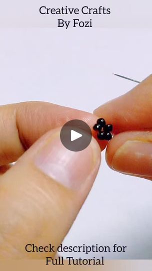 a hand holding a tiny black bead in it's left thumb, with the text creative crafts by pozi