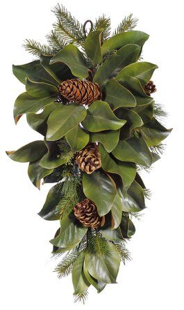 a christmas wreath with pine cones and green leaves