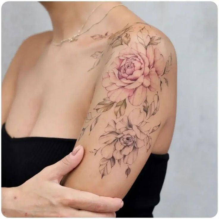 a woman's arm with flowers on it