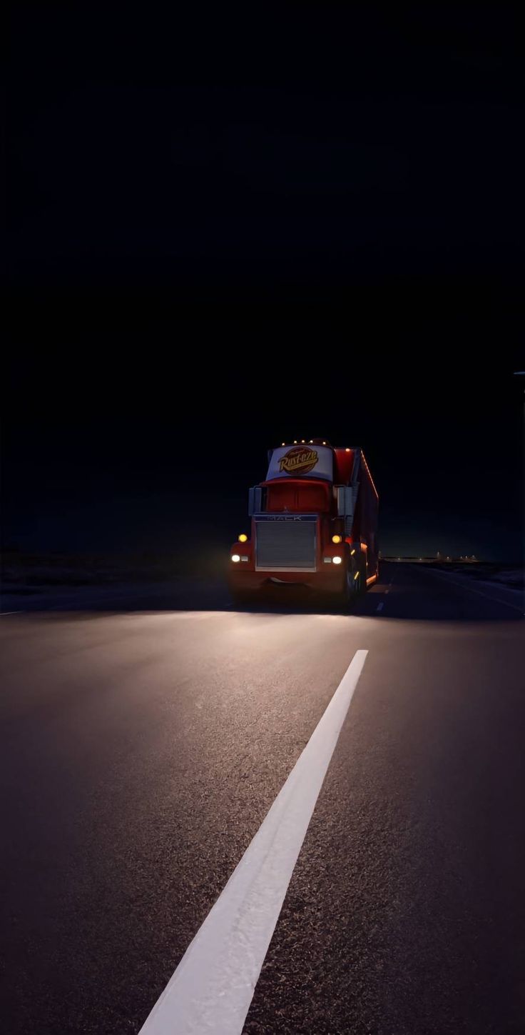 a truck driving down the road at night