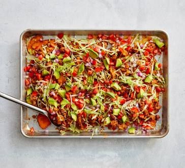 a pan filled with vegetables and sprouts on top of a white countertop