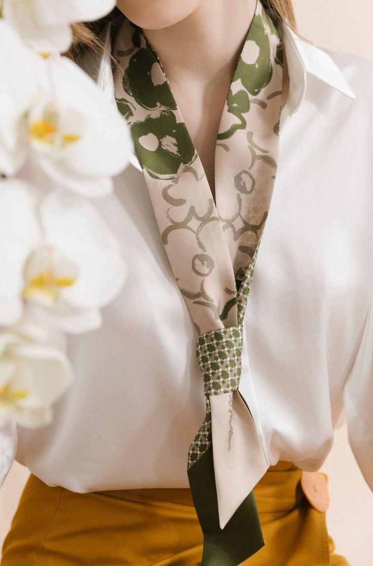 The floral graffiti design on one side of this silk skinny scarf adds a touch of fun and whimsy. The other side features a houndstooth pattern, adding another layer of sophistication to the piece. This scarf is versatile enough to be worn in many ways: as a necktie or headband, or just wrapped around your neck. It's the perfect accessory for any occasion and will make you stand out from the crowd! Product Description: 100% silk twill 120cm x 5cm ( 2"W x 47"L ) Double-sided stitching Two colors: Chic Silk Scarves For Spring, Elegant Spring Workwear Scarves, Elegant Green Scarves For Spring, Trendy Silk Scarf For Spring, Elegant Summer Scarves For Work, Elegant Spring Scarves For Workwear, Elegant Summer Scarves For Workwear, Trendy Spring Neckwear For Gifts, Trendy Patterned Scarf For Spring