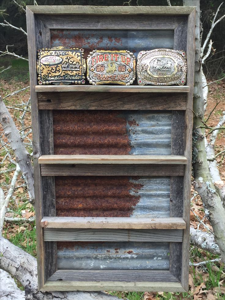 an old wooden shelf with three different types of soaps on it and some trees in the background