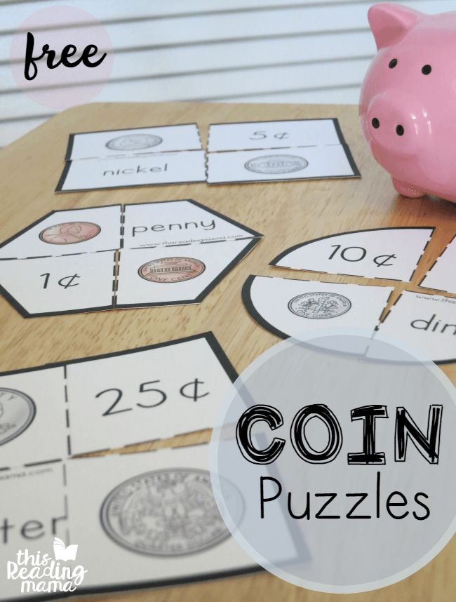 a pink piggy bank sitting on top of a table next to some cut out coins