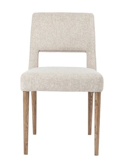 a white chair with wooden legs and a light colored upholstered armrests