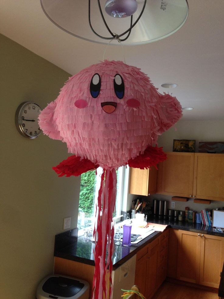 a pink kite hanging from the ceiling in a kitchen