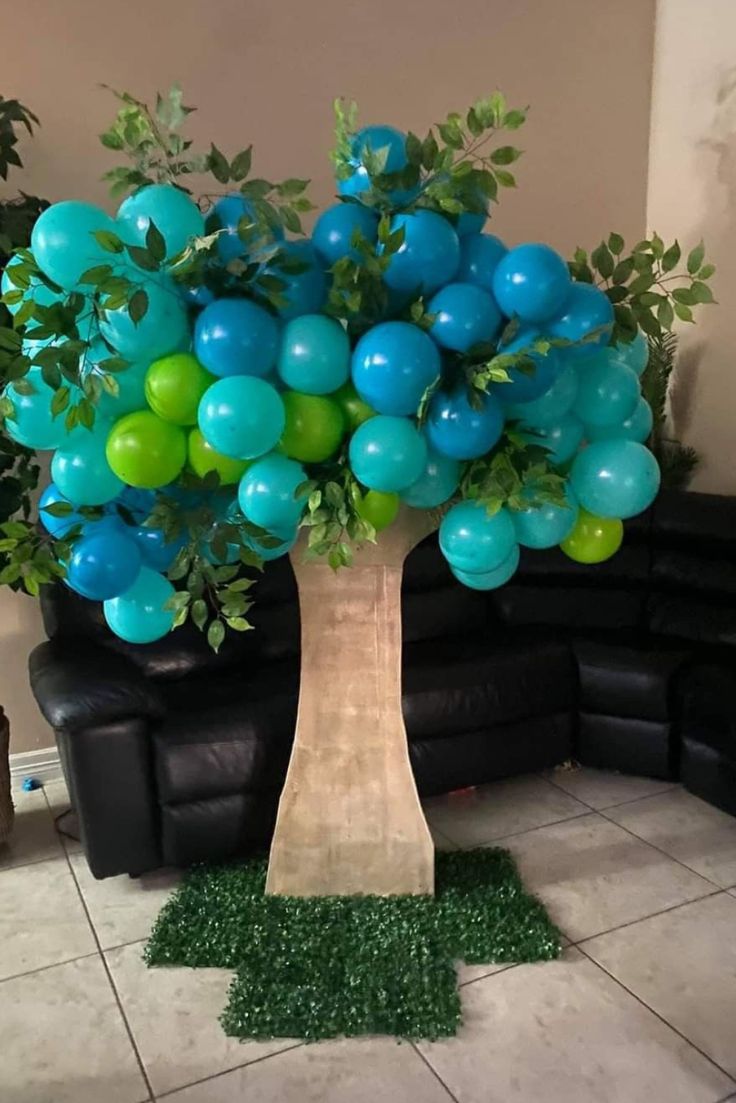 the balloon tree is decorated with blue and green balloons