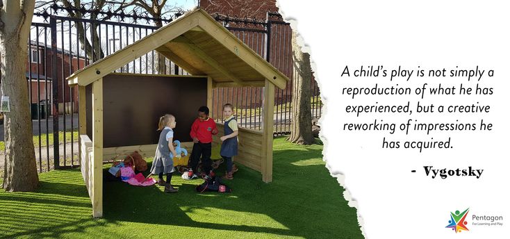 children play in a small wooden structure with a quote from tyotsky on it