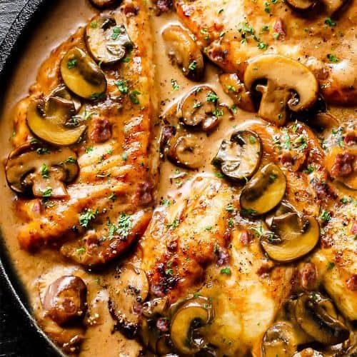 chicken with mushrooms and sauce in a skillet