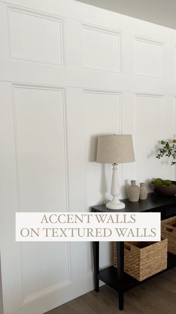 a black table with two baskets on it and a lamp next to it that says accent walls on textured walls